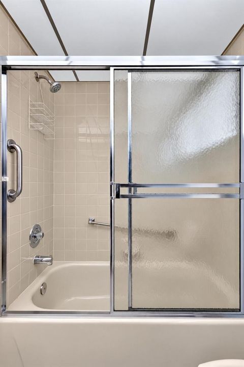 Clean Beige Tile Shower with Frosted Gla