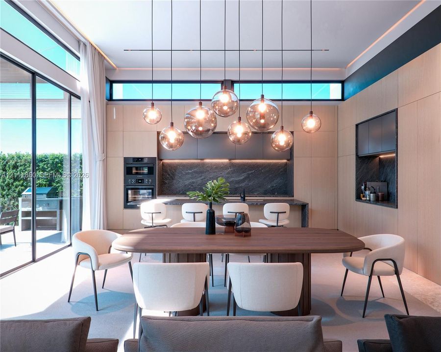 Contemporary kitchen featuring flat-panel wood cabinetry, dark stone-surfaced backsplash, integrated wall oven, floor-to-ceiling glass wall, and a multi-pendant orb light fixture