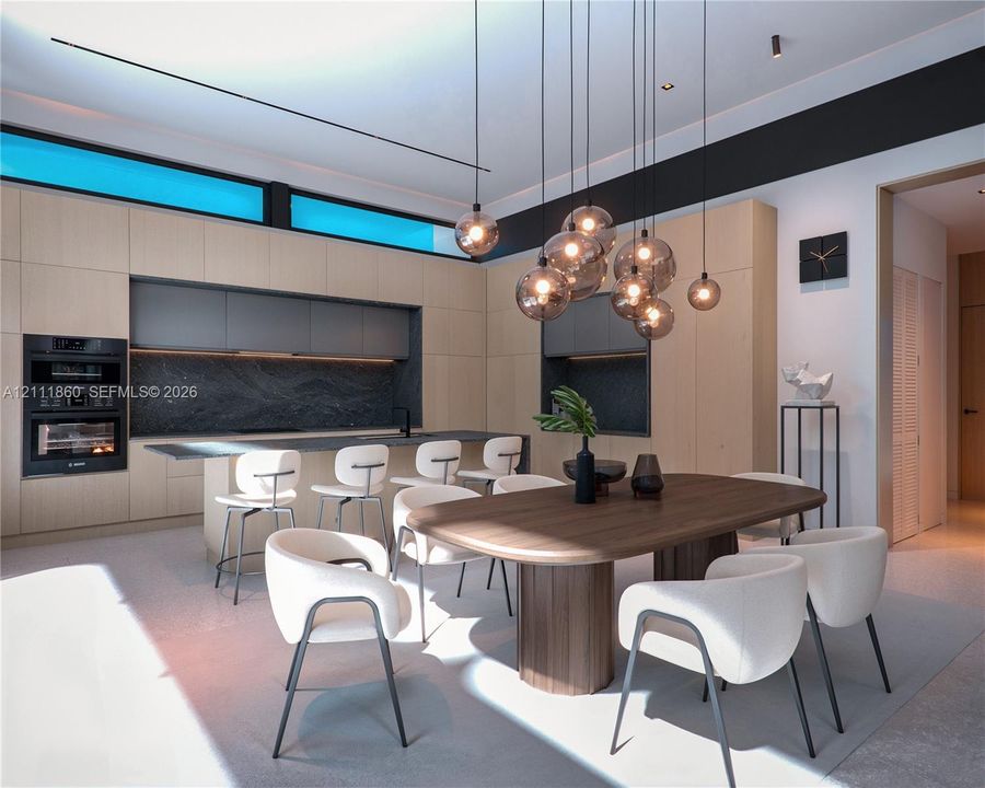 Contemporary kitchen featuring flat-panel cabinetry, a stone-surfaced island with integrated seating, recessed dark-toned backsplashes, built-in double wall ovens, and a multi-pendant light fixture