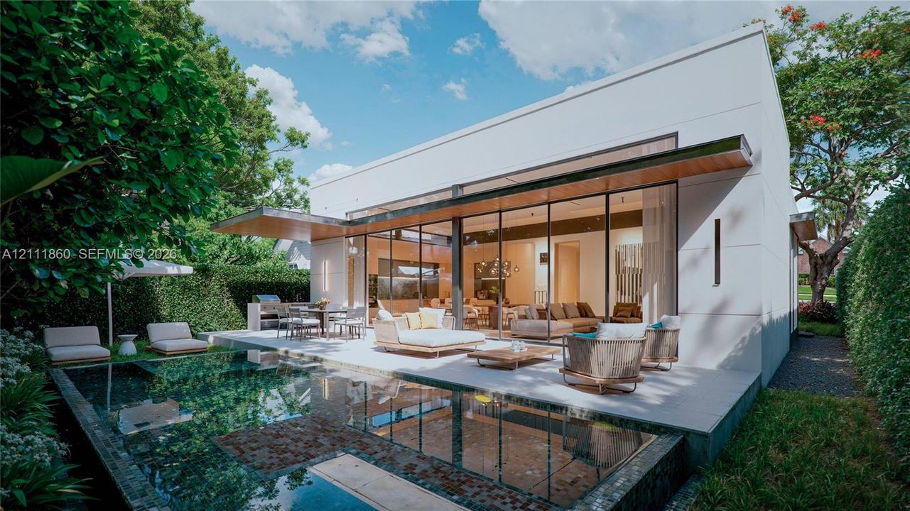 Modern architectural exterior featuring expansive floor-to-ceiling glass panel walls, a covered concrete patio, and a built-in outdoor kitchen with a stone-finish grill station