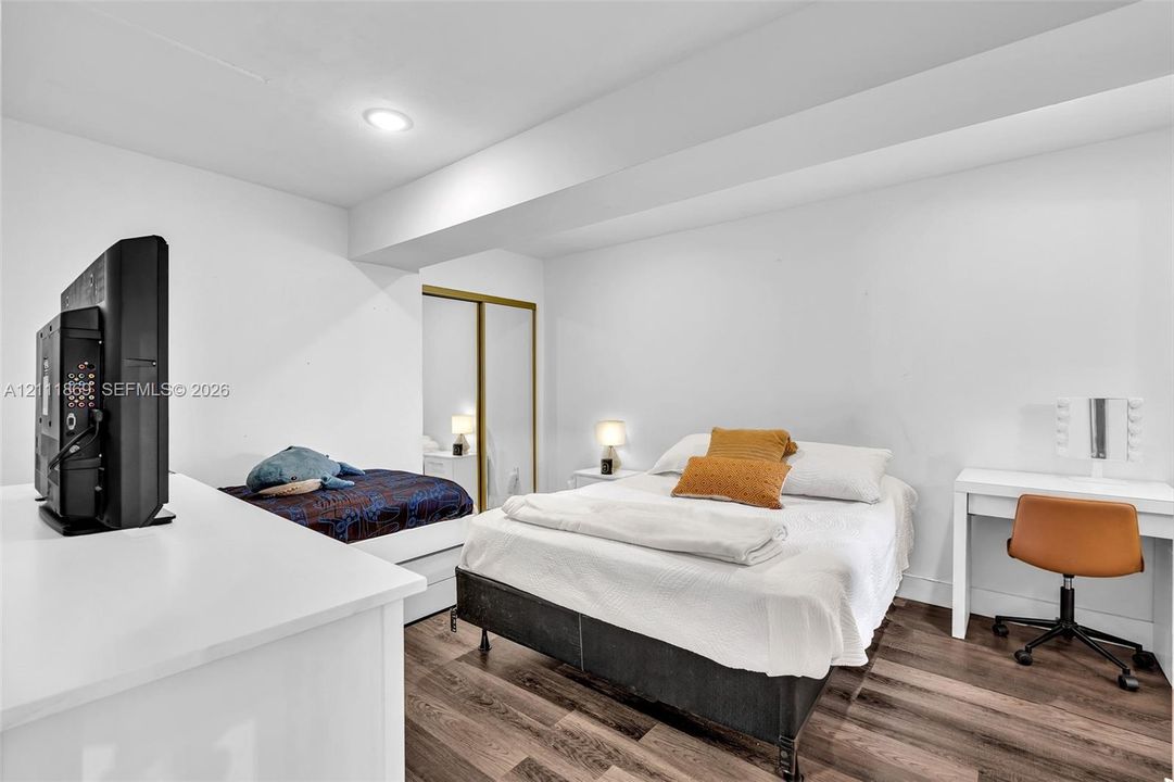 Interior space featuring wood-finish flooring, recessed lighting, and a closet with sliding mirrored doors