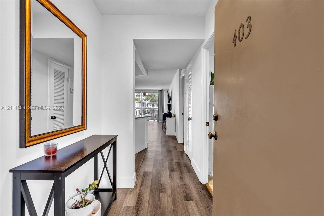 Entryway featuring wood-finish flooring and neutral wall color
