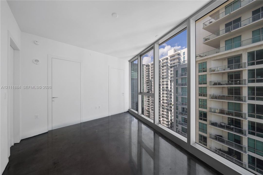 Floor-to-ceiling glass windows, polished concrete flooring, and flush-mount interior doors
