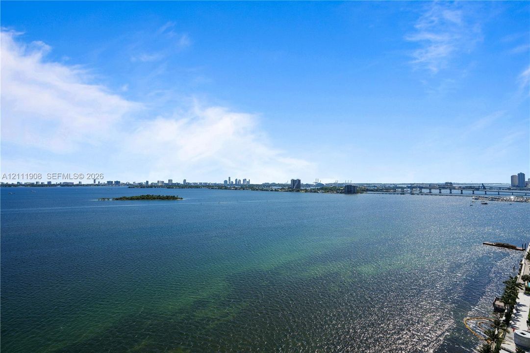 Expansive water scenery encompassing the bay, distant cityscape skyline, and island landmarks