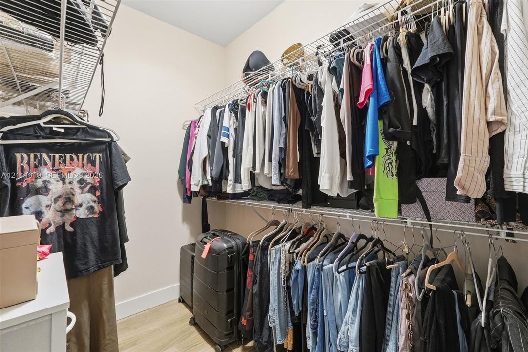 Walk-in closet featuring tiered wire shelving and light-toned hard-surface flooring