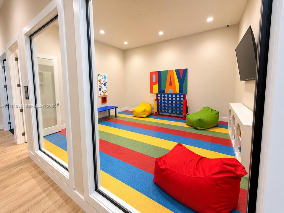 Multi-purpose room featuring glass-paneled walls, recessed lighting, multi-colored flooring, and built-in white cabinetry