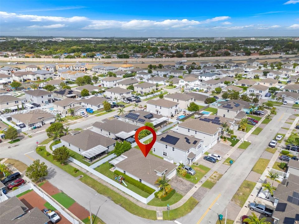 Corner-lot property featuring a fenced backyard, shingle-roof architecture, and a two-car garage