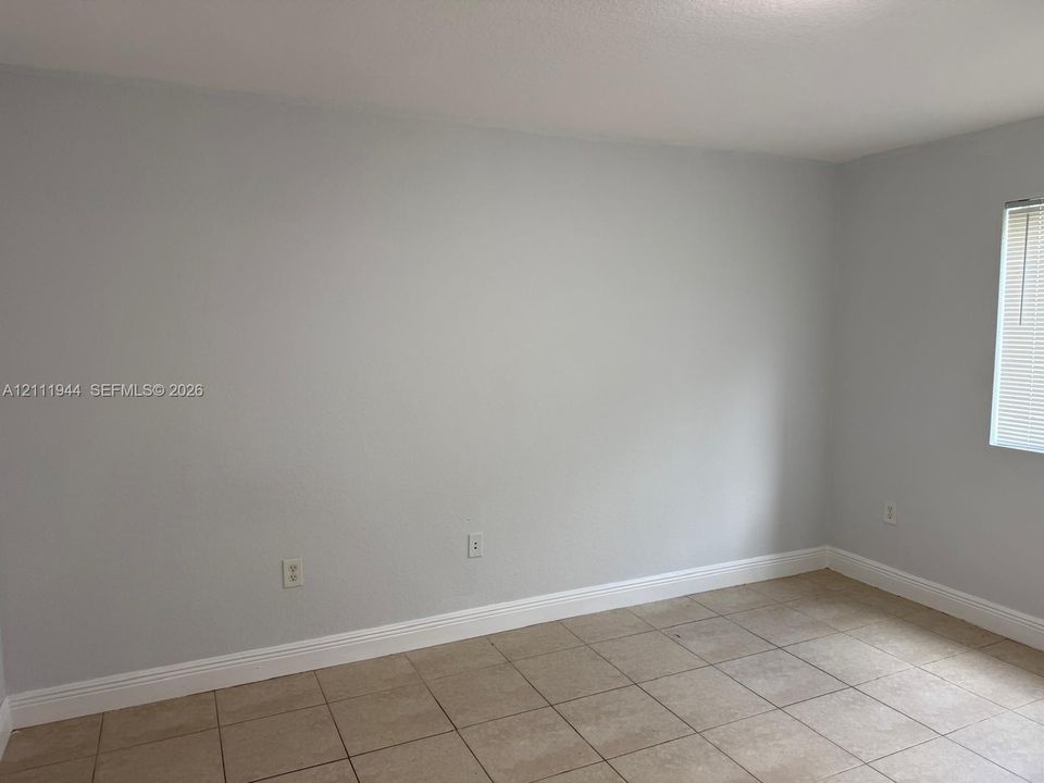 Neutral-toned walls and large-format tile flooring