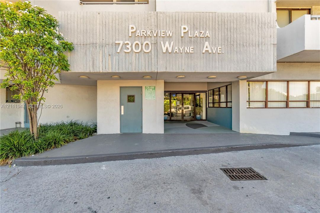 Concrete exterior facade featuring recessed lighting and glass-panel entry doors