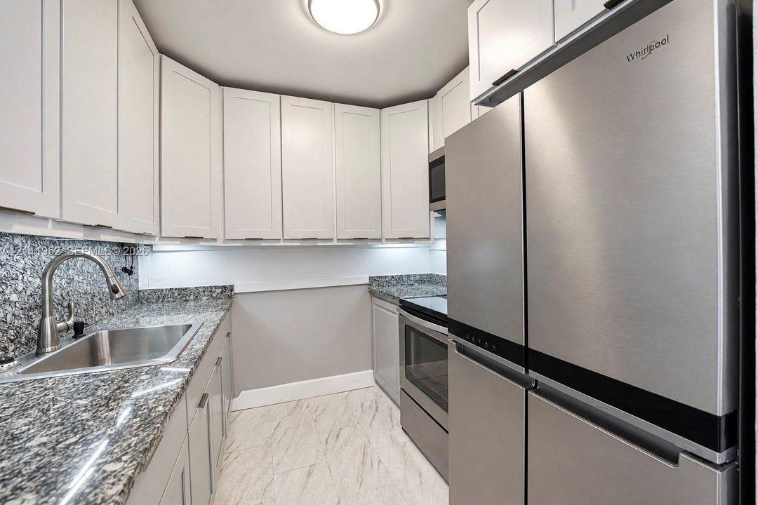 Kitchen solid wood cabinetry with additional built in, stone countertops, appliances 1-2 years old
