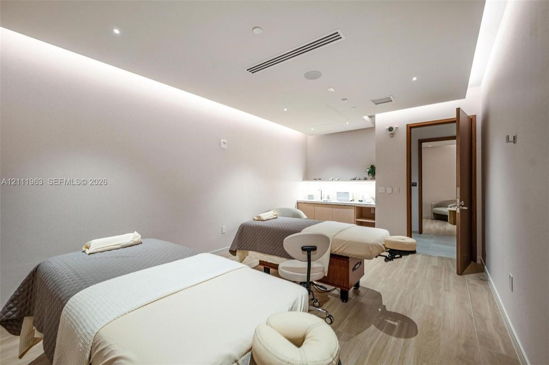 Recessed ceiling lighting, wood-finish flooring, custom built-in cabinetry with integrated under-cabinet lighting, and neutral wall tones
