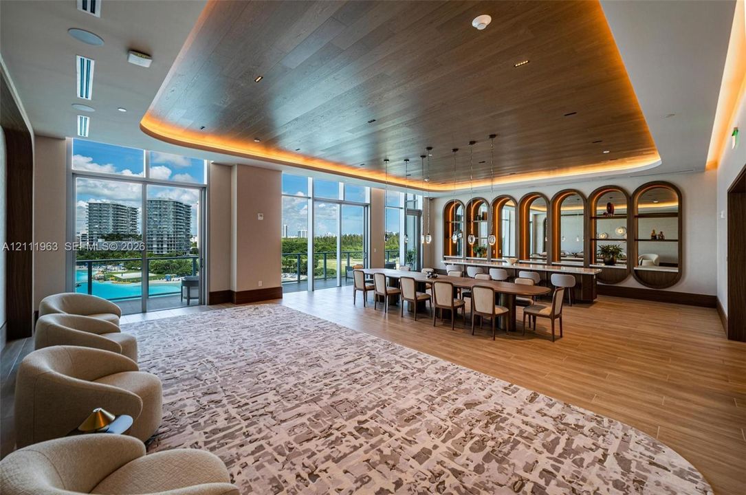 Wood-finish ceiling with recessed cove lighting, floor-to-ceiling windows, custom built-in arched shelving, and wood-finish flooring