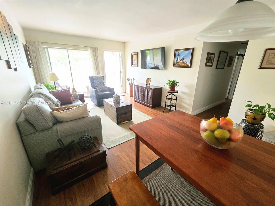 Living area featuring wood-finish flooring, sliding glass patio door, and recessed lighting