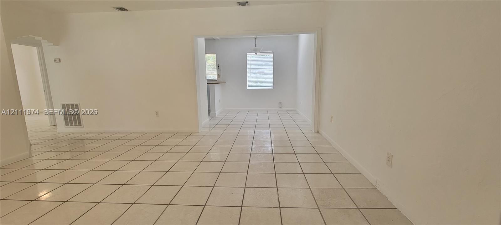 Neutral-toned ceramic tile flooring, crisp white interior paint, and recessed ceiling lighting