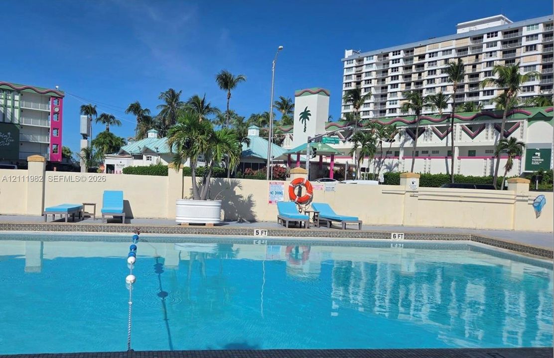 Swimming pool featuring a concrete deck, perimeter wall, and integrated safety lane markers