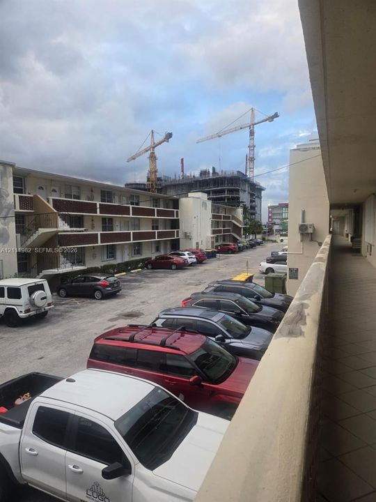 Surface parking lot with assigned spaces, exterior stairwells, and covered walkways