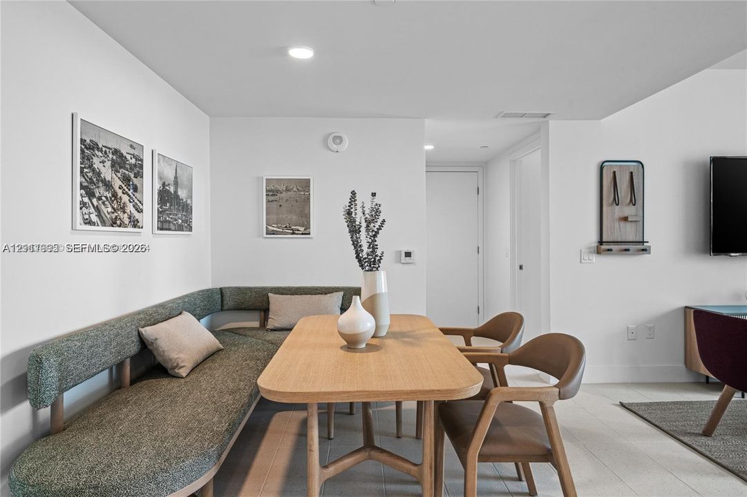 Neutral-toned interior featuring smooth walls, recessed ceiling lighting, and large-format tile flooring