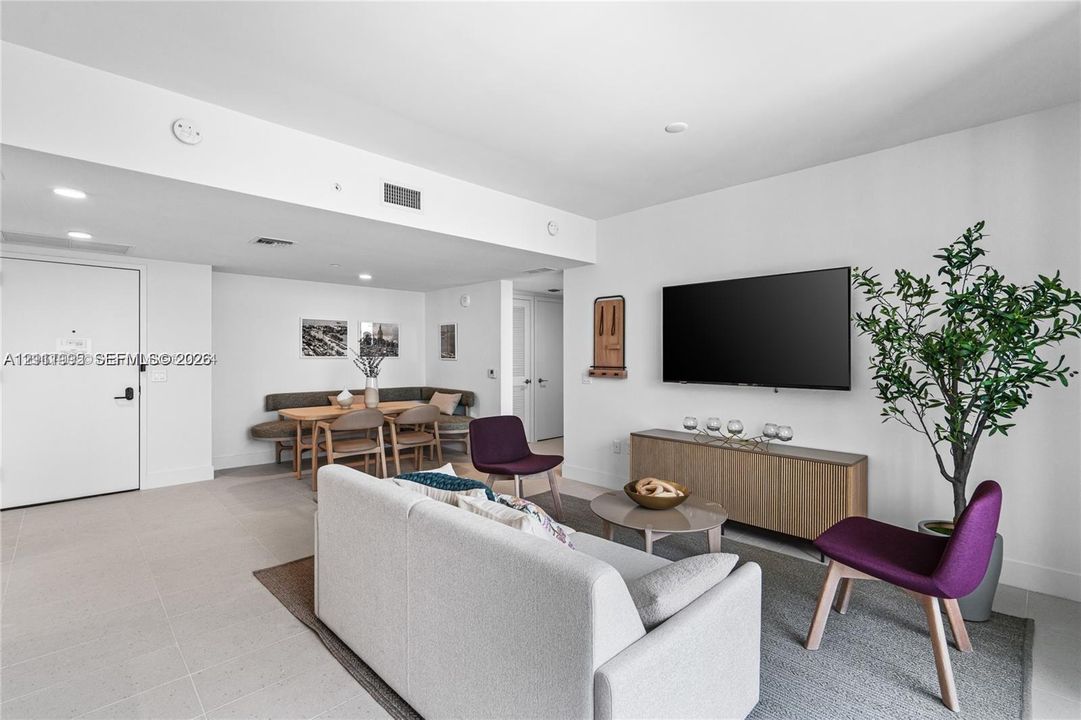 Neutral-toned interior featuring recessed lighting, smooth ceiling finish, and uniform tile flooring