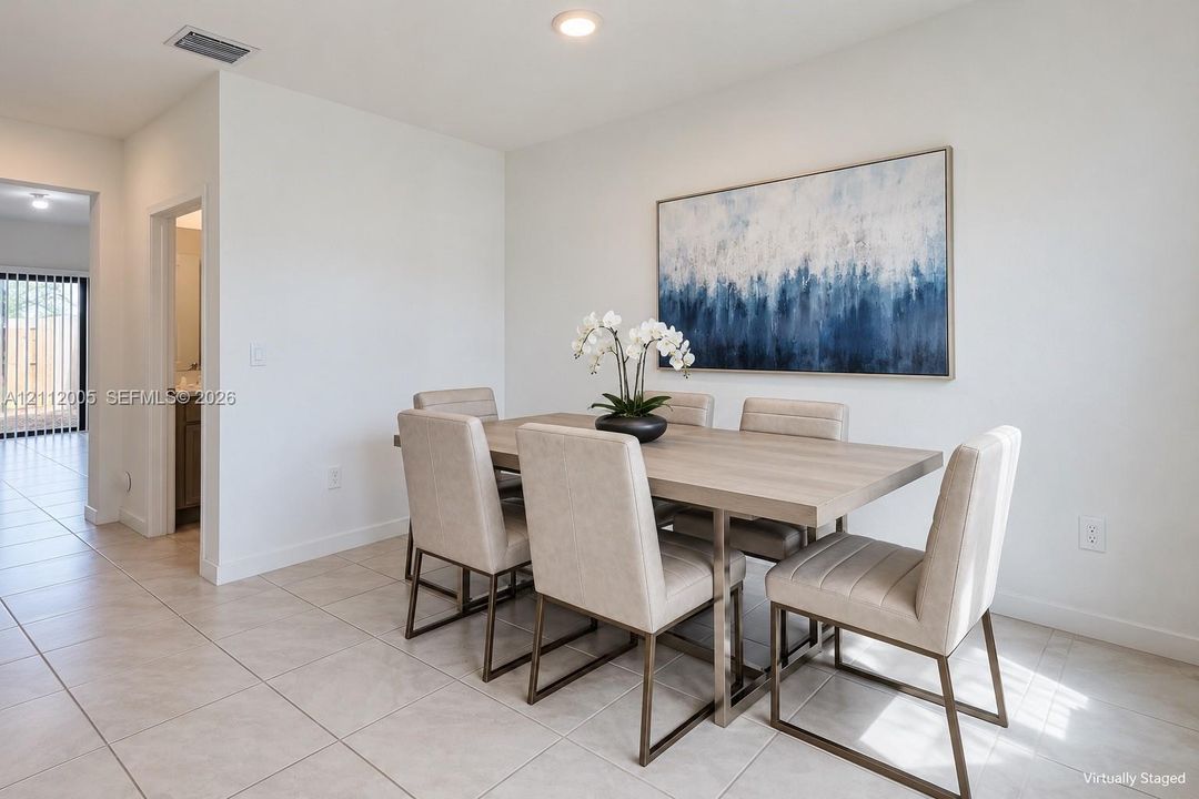 Open-concept area featuring light-toned tile flooring and recessed ceiling lighting
