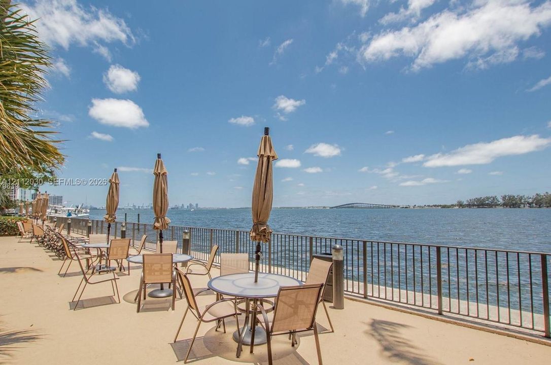 Waterfront paved terrace featuring a metal perimeter railing and direct water frontage