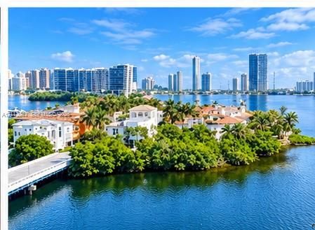 Waterfront estate featuring deep-water access, multi-story Mediterranean-style architecture, tile roofing, private bridge entry, and mature tropical landscaping