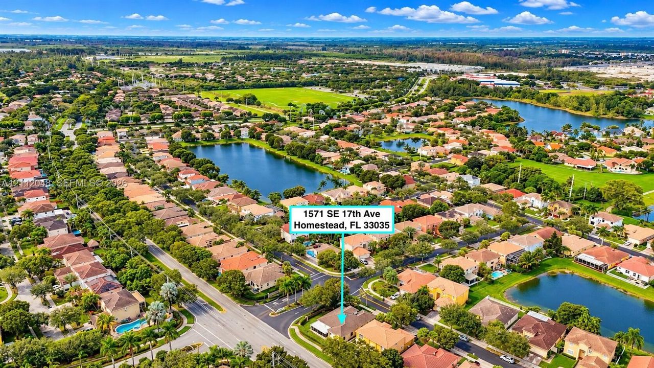 Aerial perspective of a suburban neighborhood featuring paved street infrastructure, multi-parcel residential development, and established landscaping