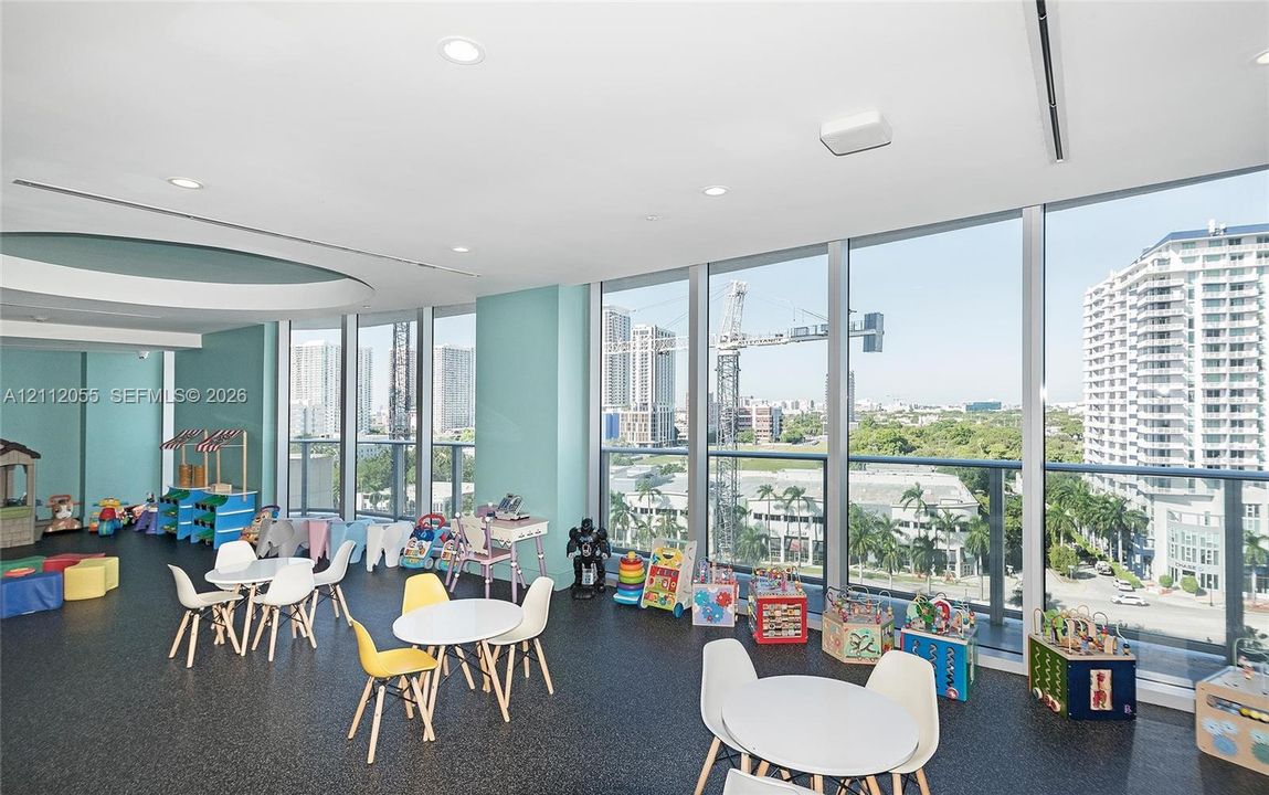 Floor-to-ceiling windows, recessed lighting, and high-contrast flooring