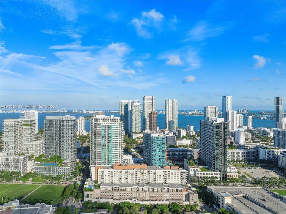 Aerial perspective of the urban skyline, high-rise architecture, and coastal waterway