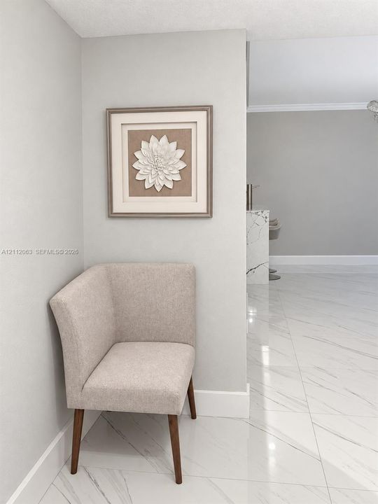 Large-format polished stone flooring with neutral veining throughout