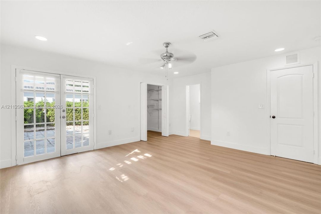 Interior featuring wood-finish flooring, recessed lighting, a ceiling fan, and double glass-paned doors with exterior access