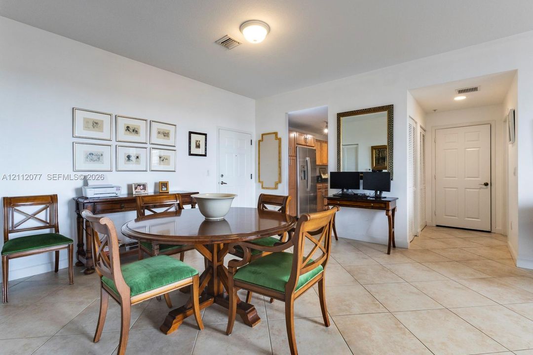 Open-concept living space featuring diagonal tile flooring, high ceilings, flush-mount lighting, and solid-core interior doors