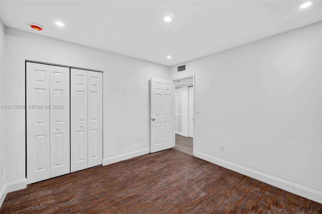 Interior room featuring wood-finish flooring, recessed lighting, and a bi-fold closet