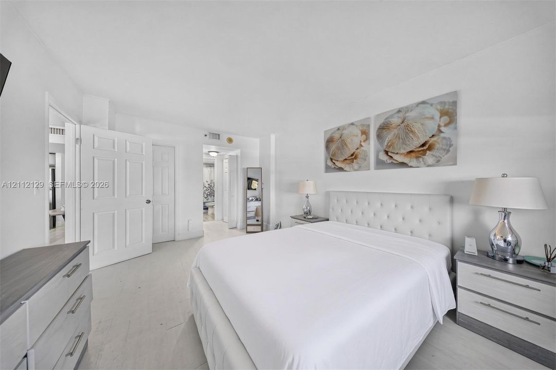 Neutral color palette featuring white walls, multi-panel interior doors, and light-toned flooring