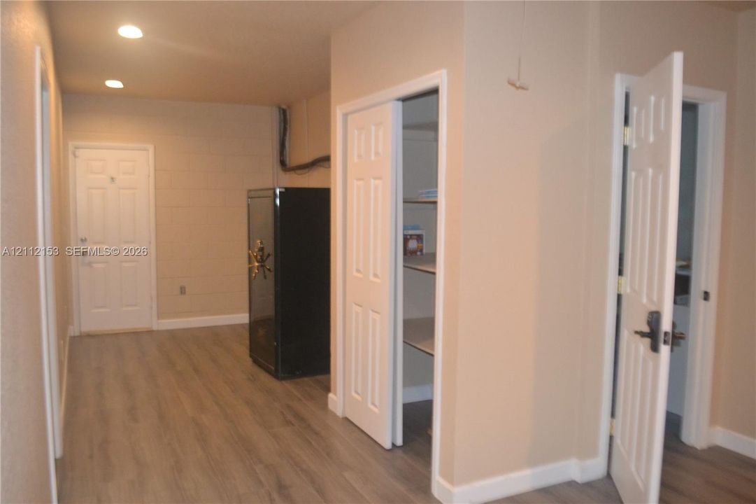 Interior space featuring wood-finish flooring, recessed lighting, and multiple interior paneled doors