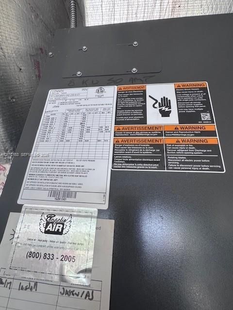 Lennox heat pump air handling unit featuring a black metal cabinet, integrated safety warning labels, and a system specification data plate