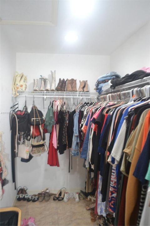 Storage area featuring multi-tier wire shelving and tile flooring