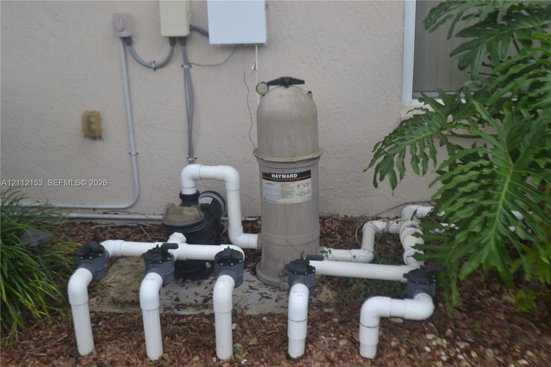 External Hayward pool filtration system with PVC plumbing and multi-valve configuration
