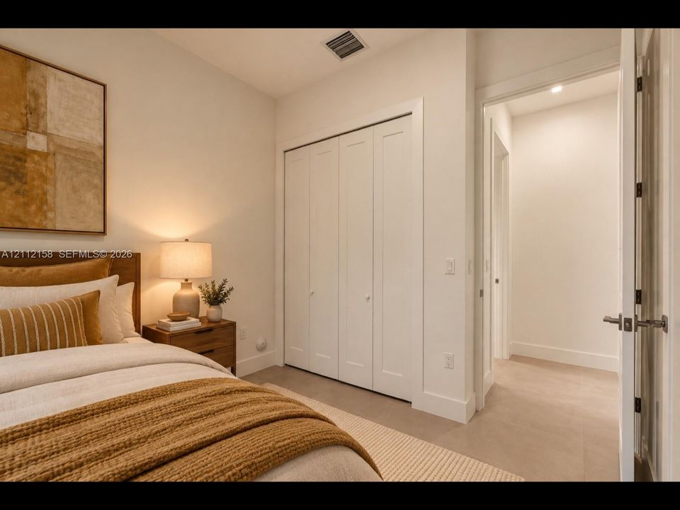 (Digitally staged) Bright, versatile bedroom with clean finishes, easy-care tile flooring, and a bi-fold closet
