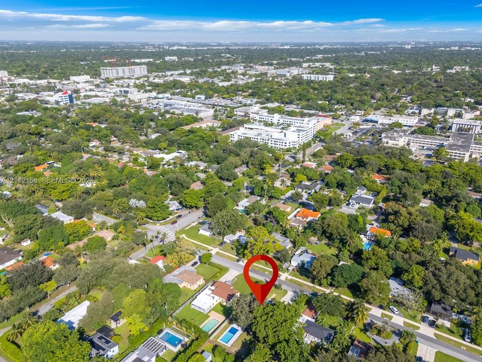 Aerial view highlighting the home's private setting surrounded by lush greenery