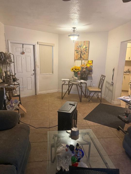 Interior space featuring tile flooring, neutral wall paint, and a classic semi-flush mount light fixture