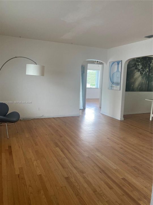 Interior featuring wood-finish flooring and arched doorways