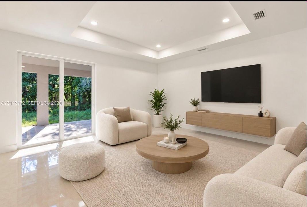 Tray ceiling with recessed lighting, large sliding glass doors, and wall-mounted cabinetry