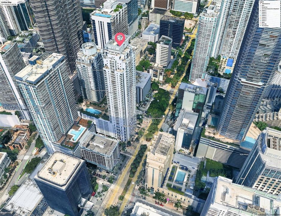Aerial perspective of a high-rise condominium tower featuring a glass facade, multiple terraces, and a structured podium base situated within a dense urban center
