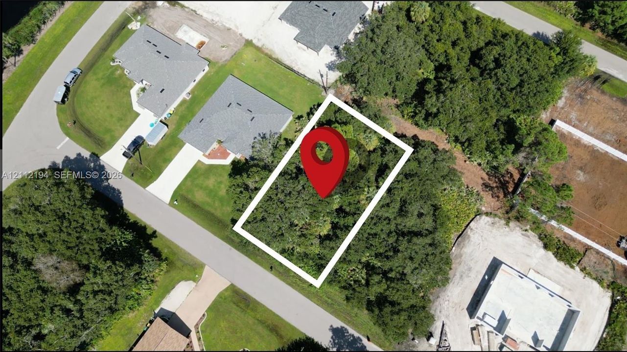 Rectangular parcel featuring mature vegetation and established tree cover, situated on a paved street
