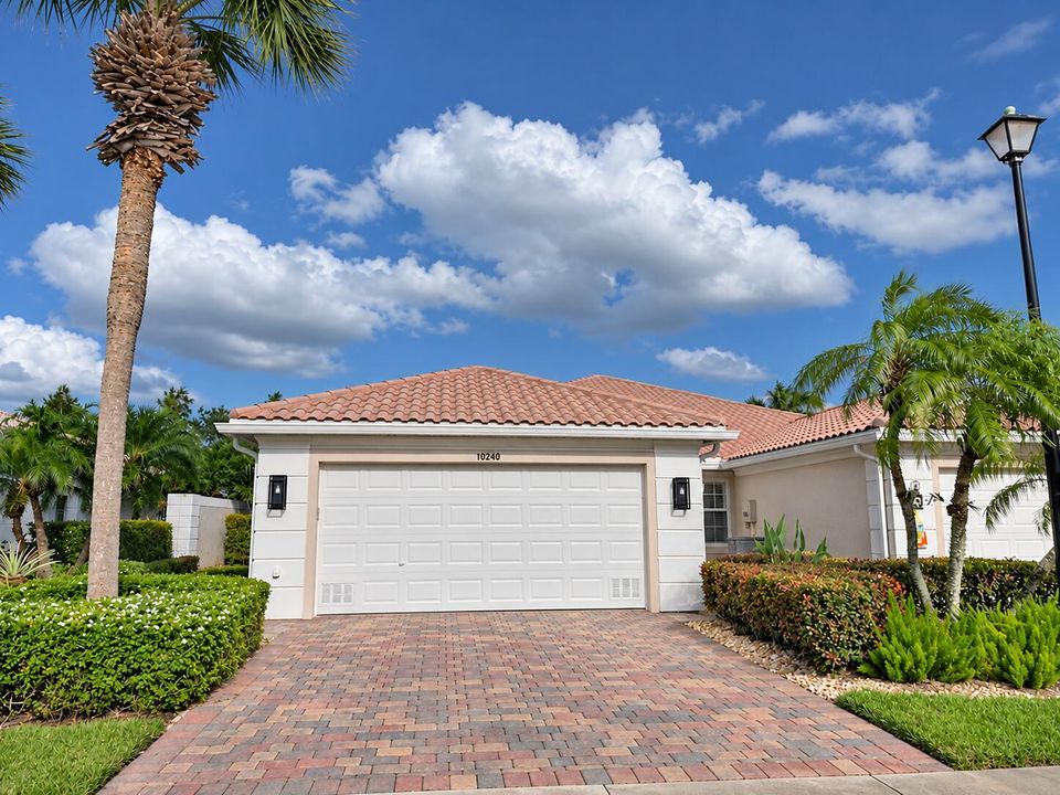 Suburban House with Palm Trees and Hedge