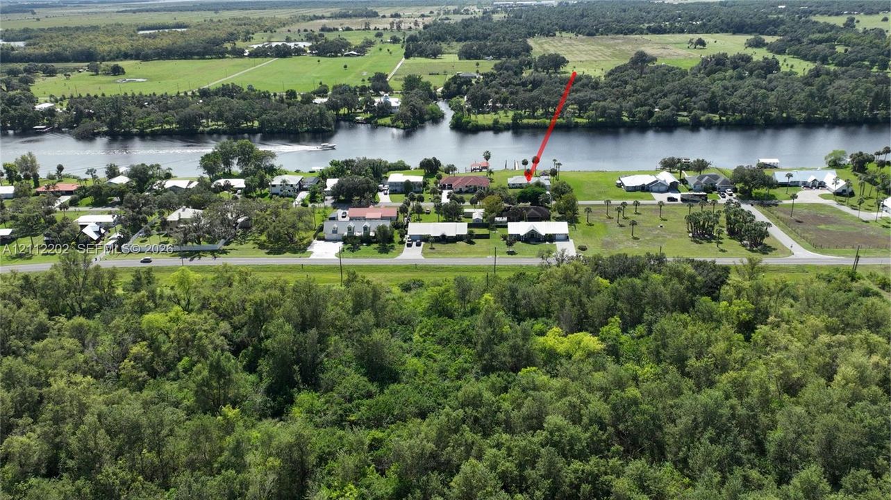 Waterfront property featuring extensive acreage, mature trees, and direct river access