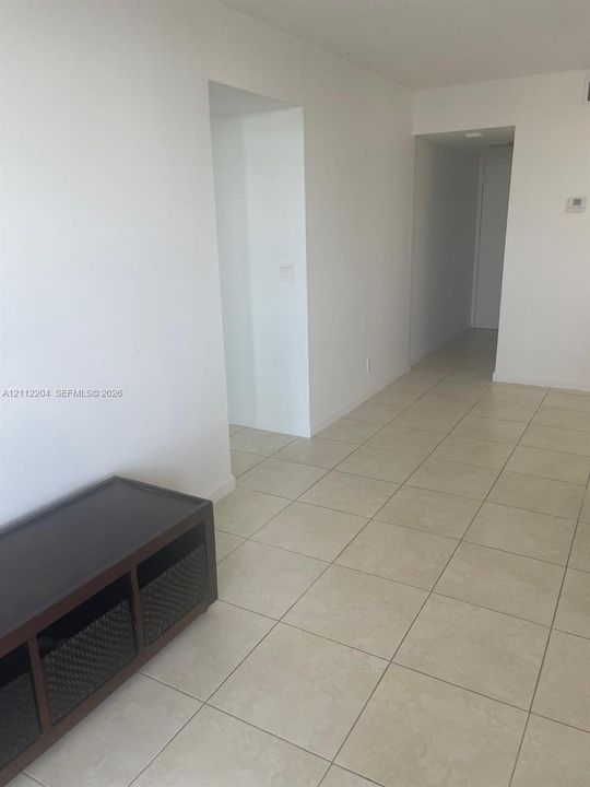 Neutral ceramic tile flooring and white wall finishes