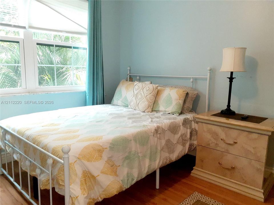 Room featuring hardwood flooring and a multi-pane window assembly