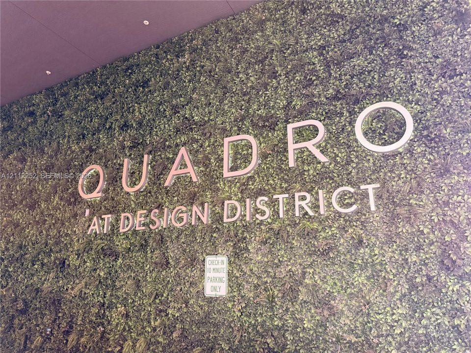 Exterior living wall feature with integrated dimensional signage