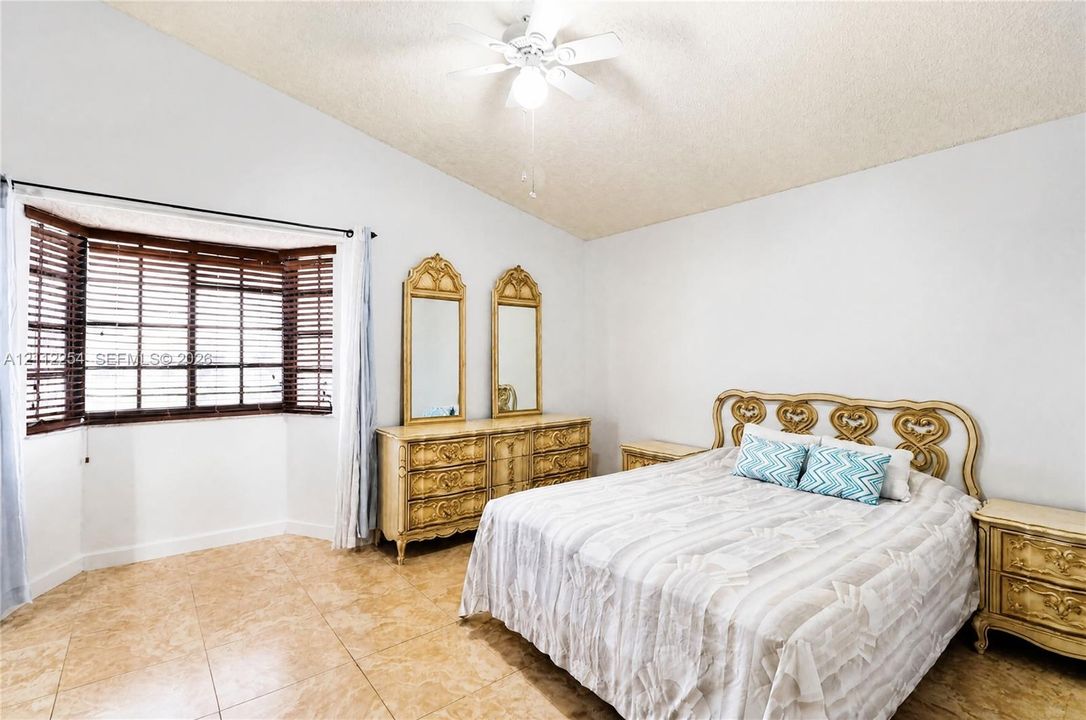 Vaulted ceilings, large bay window, and tile flooring